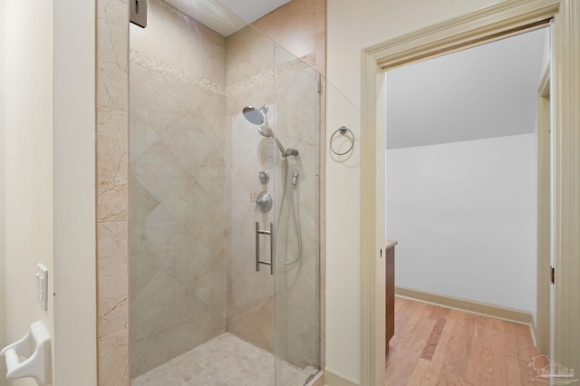 bathroom featuring walk in shower and hardwood / wood-style floors