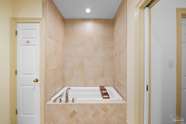 bathroom with tiled tub