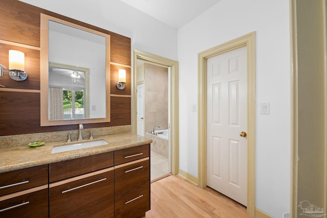 bathroom featuring a bathtub, wood-type flooring, and vanity