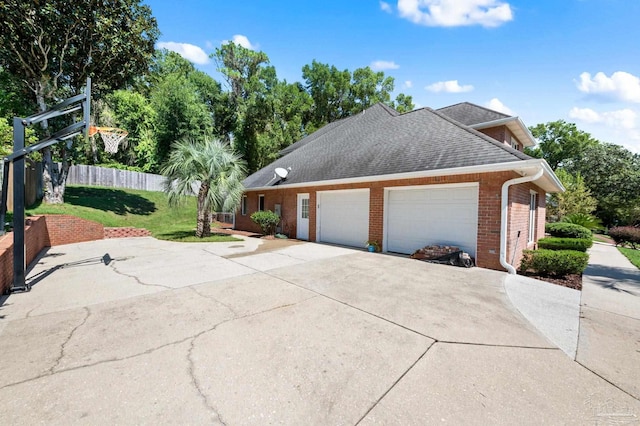 view of side of property featuring a lawn and a garage