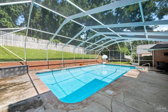 view of pool featuring a lanai, a patio area, and a yard