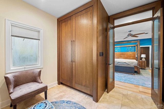 living area featuring ceiling fan and light hardwood / wood-style flooring