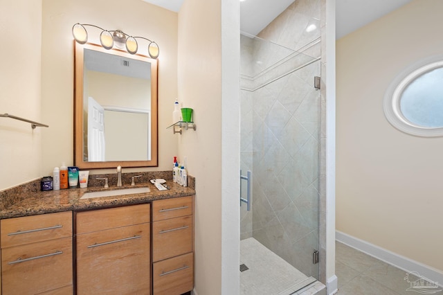 bathroom featuring vanity, tile patterned flooring, and an enclosed shower