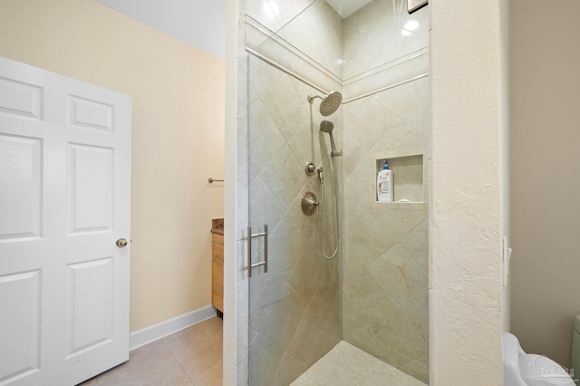 bathroom featuring vanity, toilet, tile patterned floors, and an enclosed shower