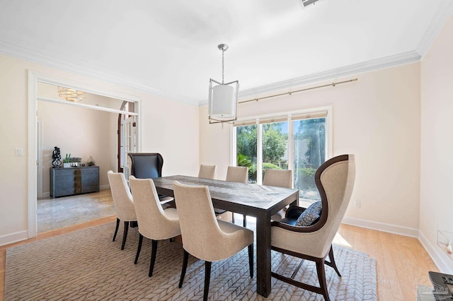 dining room featuring ornamental molding and light hardwood / wood-style floors