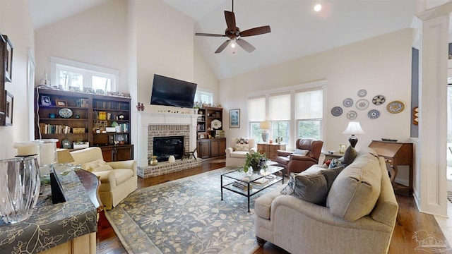 living room featuring wood-type flooring, high vaulted ceiling, and a wealth of natural light