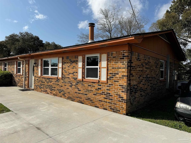 view of property exterior featuring brick siding