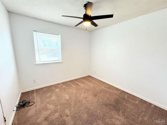 carpeted empty room with baseboards, a textured ceiling, and ceiling fan