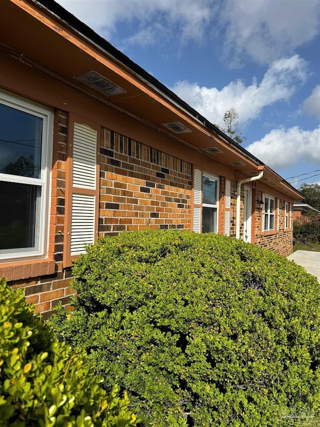 view of property exterior featuring brick siding