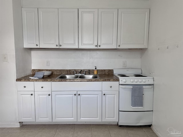 kitchen featuring electric range, a sink, white cabinetry, baseboards, and dark countertops