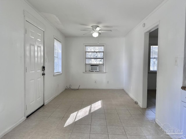 interior space featuring light tile patterned floors, ceiling fan, crown molding, and a wealth of natural light