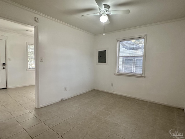 empty room with baseboards, plenty of natural light, a ceiling fan, and crown molding