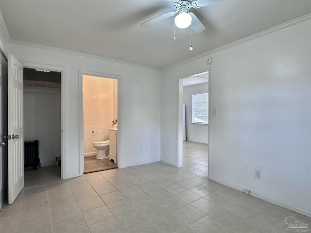 unfurnished bedroom featuring ornamental molding, a closet, ensuite bath, and light tile patterned floors