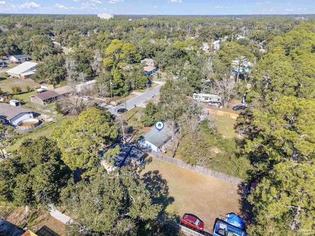 bird's eye view with a wooded view