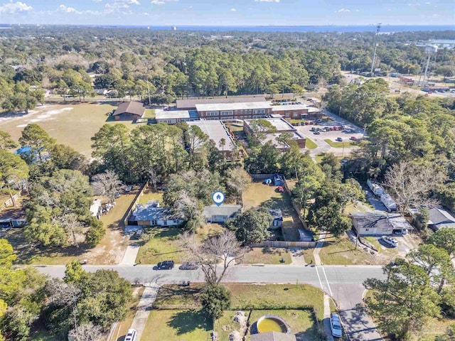 drone / aerial view featuring a view of trees