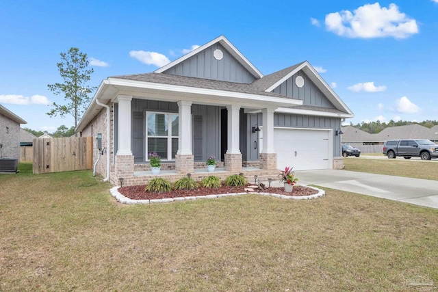 craftsman house with board and batten siding, brick siding, driveway, and a front lawn