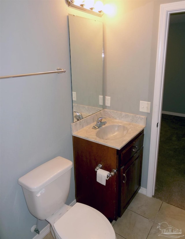 bathroom with vanity, toilet, and tile patterned flooring