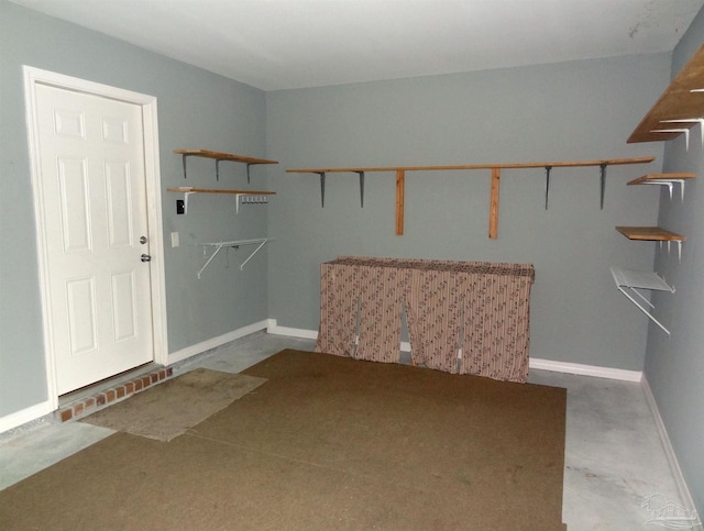 walk in closet with carpet flooring