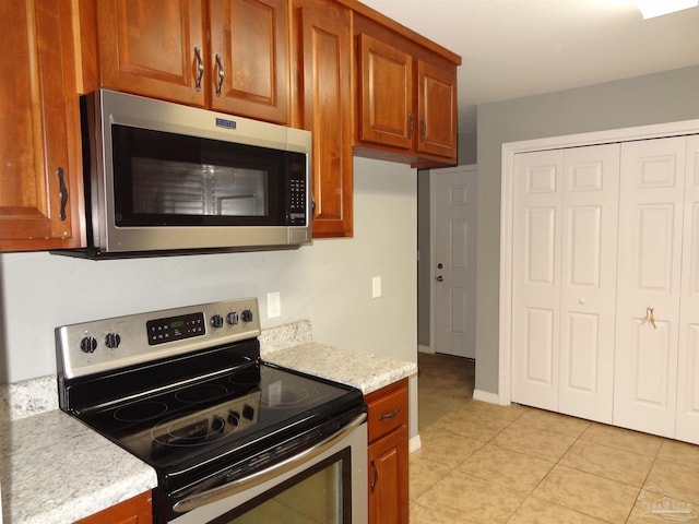 kitchen with appliances with stainless steel finishes and light tile patterned floors