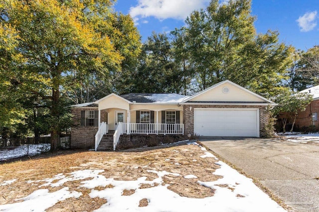 single story home featuring a porch and a garage