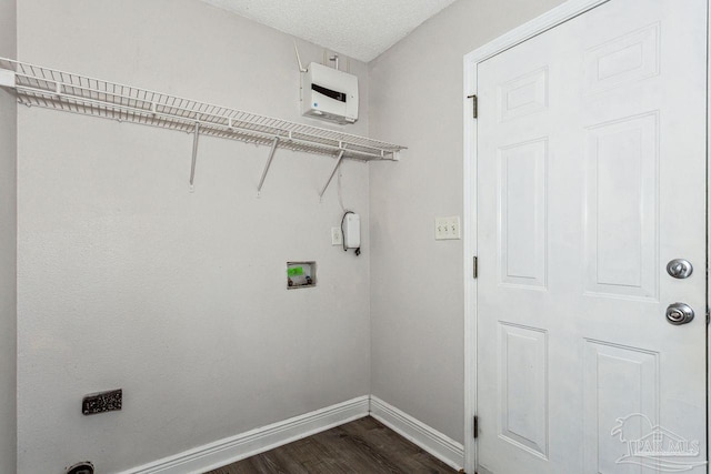 laundry room with dark hardwood / wood-style floors, washer hookup, and a textured ceiling