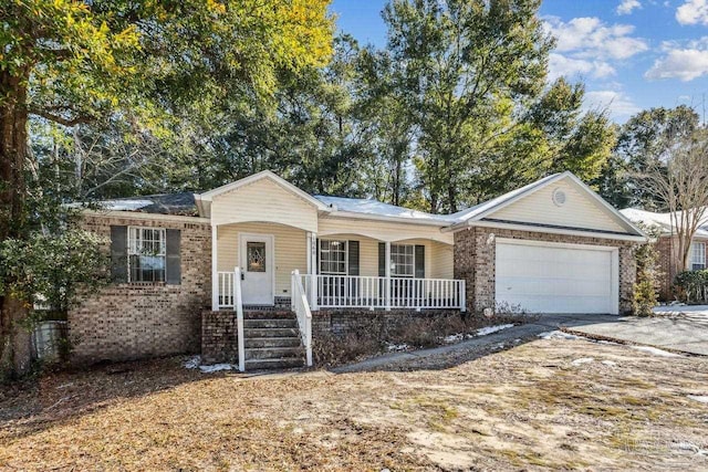 single story home with a garage and covered porch