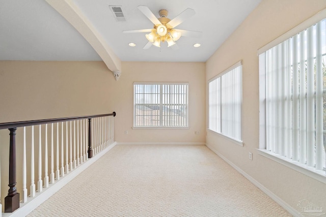 interior space with ceiling fan and beam ceiling