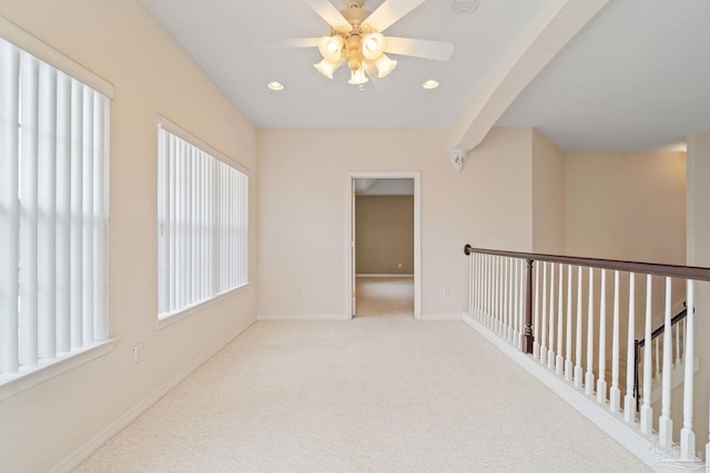 corridor featuring light colored carpet