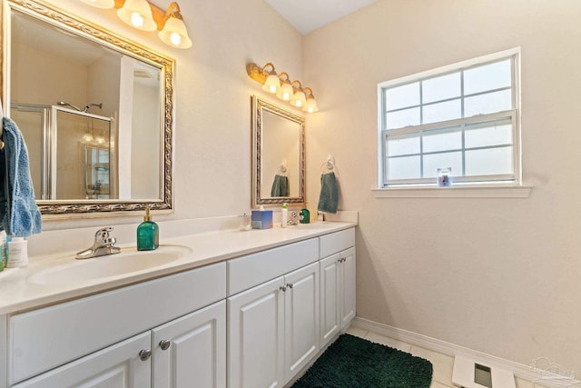 bathroom with vanity, a shower with door, and tile patterned flooring