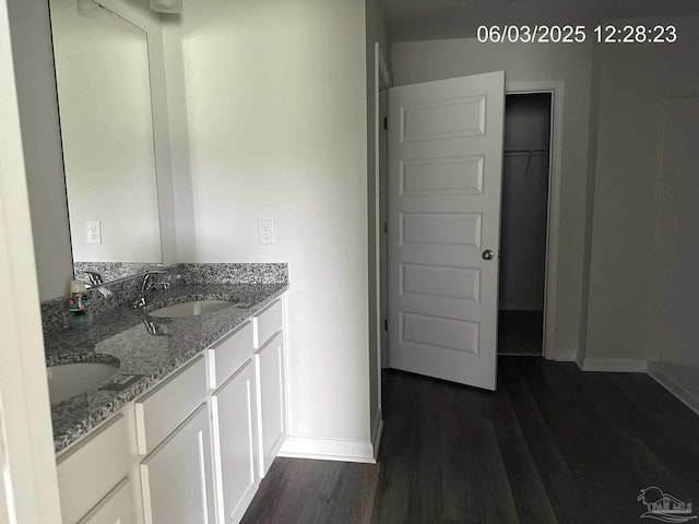 8659 Tarsus Dr, Milton, FL 32583 - full bath featuring baseboards, wood finished floors, and double vanity