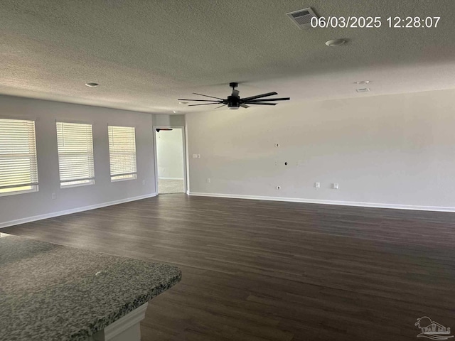 8659 Tarsus Dr, Milton, FL 32583 - unfurnished living room featuring dark wood-type flooring, a ceiling fan, a textured ceiling, and baseboards