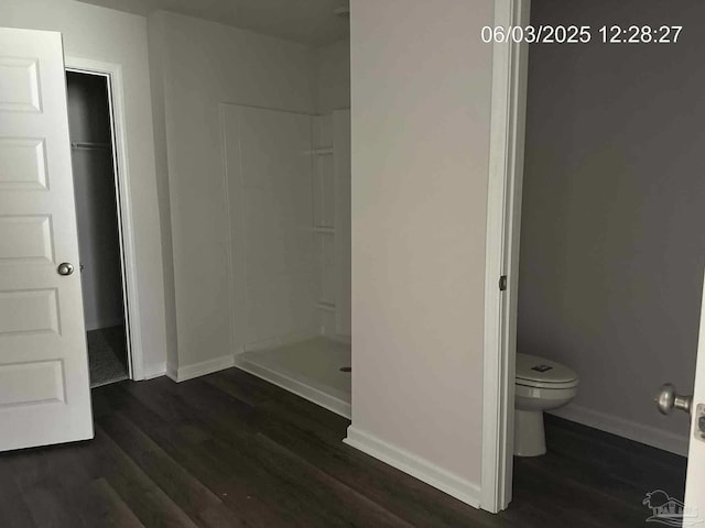 8659 Tarsus Dr, Milton, FL 32583 - full bathroom featuring a stall shower, toilet, wood finished floors, and baseboards