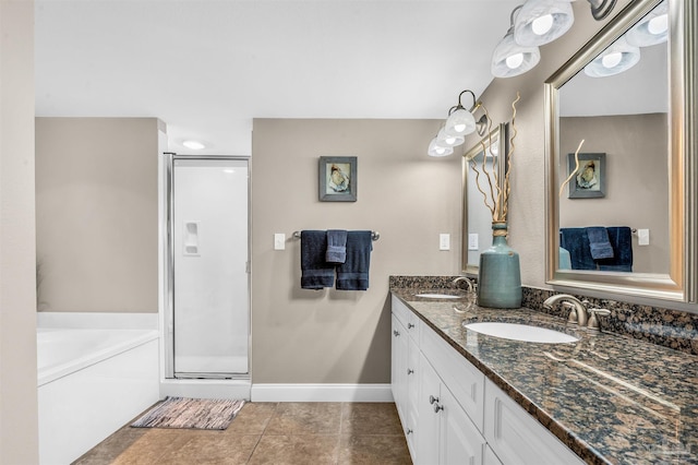 bathroom featuring double vanity, a shower stall, a garden tub, and a sink