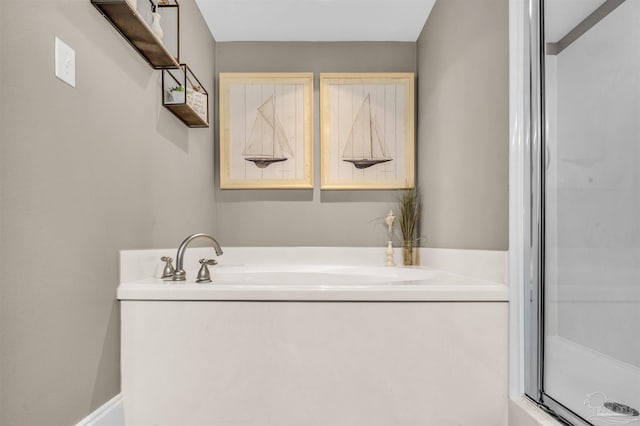 bathroom featuring a garden tub and a stall shower