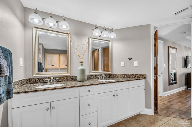 full bathroom featuring tile patterned floors, double vanity, visible vents, and a sink