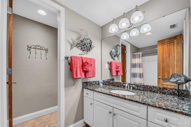 bathroom with tile patterned floors, visible vents, a shower with curtain, baseboards, and vanity