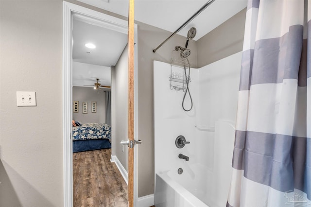 bathroom with shower / tub combo with curtain, wood finished floors, connected bathroom, baseboards, and ceiling fan