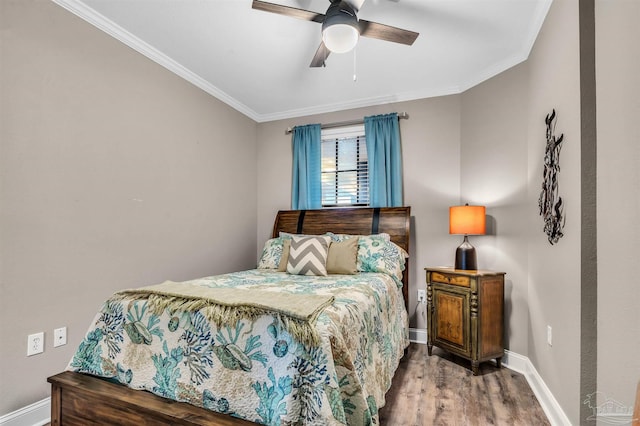 bedroom with crown molding, wood finished floors, baseboards, and ceiling fan