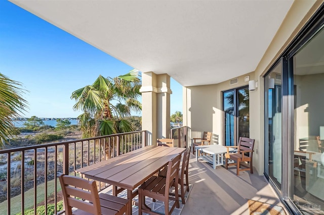 balcony featuring visible vents and outdoor dining space