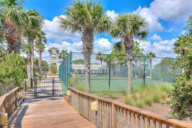 view of sport court featuring a gate and fence