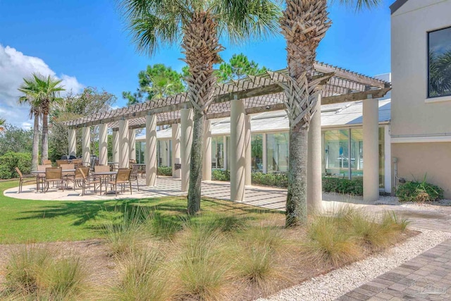 view of property's community with a pergola and a patio