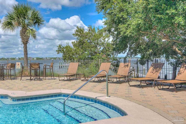 view of swimming pool with a patio area and fence