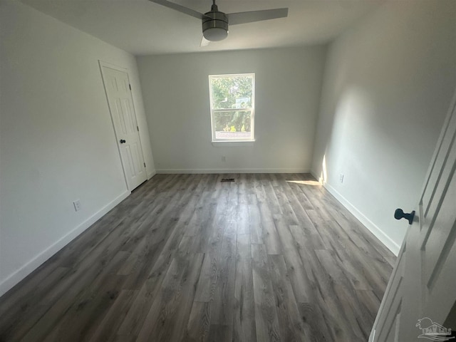 empty room with ceiling fan and hardwood / wood-style floors