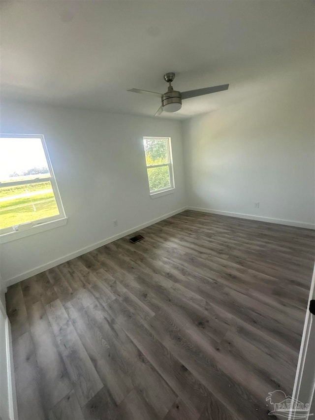 empty room with hardwood / wood-style floors and ceiling fan