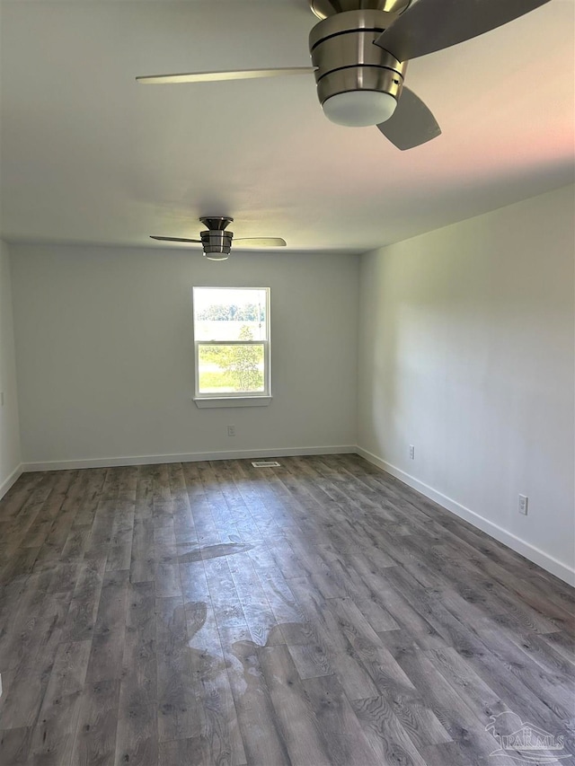 empty room with ceiling fan and wood-type flooring