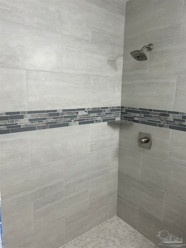 bathroom with tiled shower