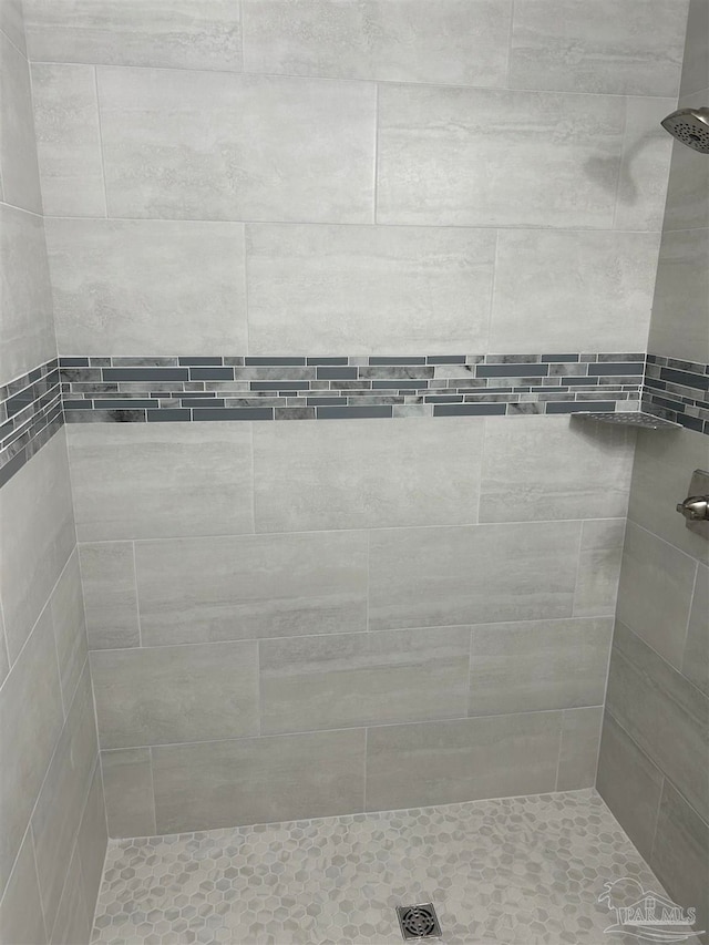 bathroom with tiled shower