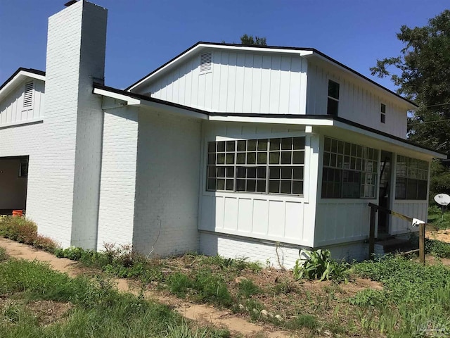 view of side of property featuring a sunroom