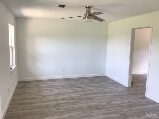 spare room with hardwood / wood-style flooring and ceiling fan