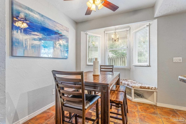 dining room with tile patterned flooring and ceiling fan with notable chandelier